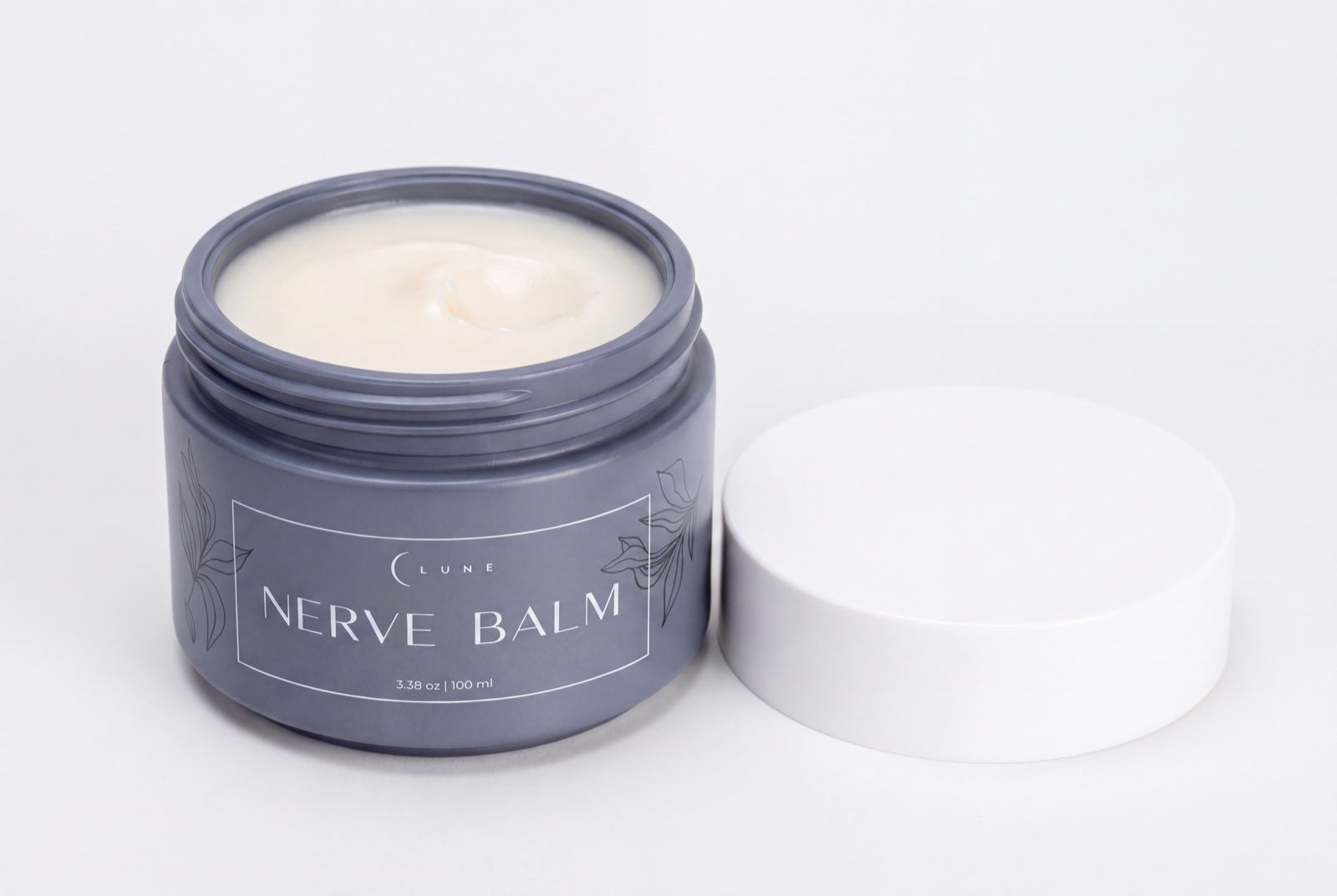 A jar of Lune Nerve Balm on a wooden nightstand beside a glucose meter and a notebook.